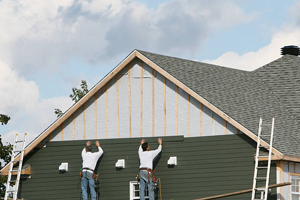 Professional Storm Damage Siding Repair technician working in Lowell, IN